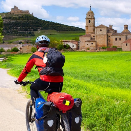 Pilgrim on a bicycle arriving in Castrojeriz (Burgos)