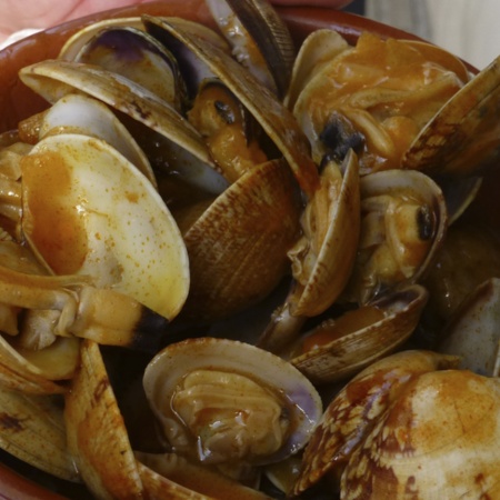 Cazuela de almejas (clam casserole), one of the traditional dishes at the Seafood Festival in O Grove (Pontevedra, Galicia)