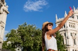 Tourist taking a selfie in Plaza Cibeles, Madrid