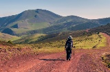 Hiker walking in the Sierra Cebollera mountain range on a sunny day, La Rioja