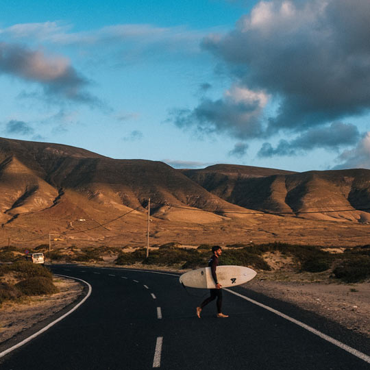 Surfer on a road in Lanzarote (Canary Islands)
