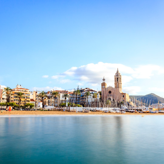 Views of Sitges beach and the church of Sant Bartomeu, located in the Port of Sitges