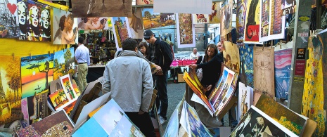 Visitors looking at a stall at El Rastro street market in Madrid