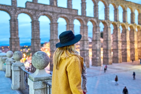 Girl looking at the Roman aqueduct of Segovia