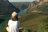 Young man looking out over the River Tagus on its course through the Monfragüe National Park.
