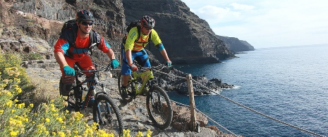 Ciclista mentre pedala lungo la costa di La Palma, isole Canarie
