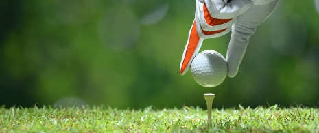 Hand placing a golf ball